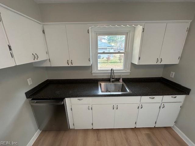 kitchen with dishwasher, sink, white cabinets, and light hardwood / wood-style flooring