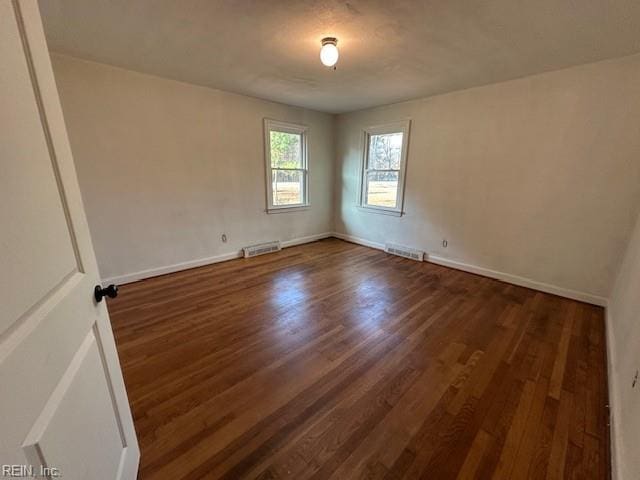 spare room featuring dark hardwood / wood-style flooring