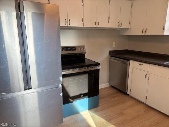 kitchen featuring white cabinets, light wood-type flooring, and appliances with stainless steel finishes