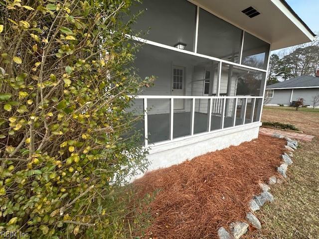 view of property exterior with a sunroom