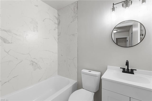 full bathroom featuring tiled shower / bath, vanity, and toilet