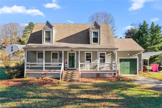 cape cod-style house with a front lawn, covered porch, a garage, and a carport