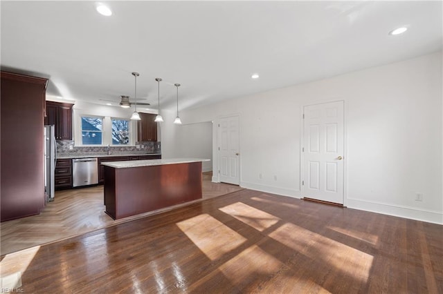 kitchen featuring a center island, hanging light fixtures, decorative backsplash, dark hardwood / wood-style floors, and stainless steel appliances