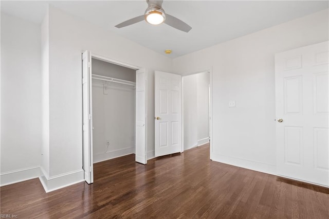 unfurnished bedroom featuring dark hardwood / wood-style floors, ceiling fan, and a closet