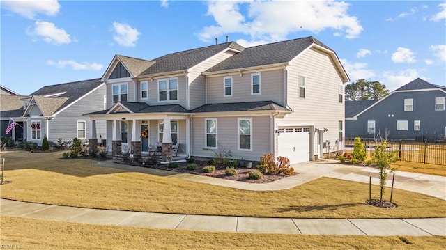 craftsman-style house with a front yard, a porch, and a garage