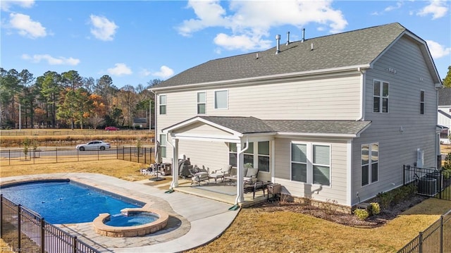 back of property with a patio, central AC, and a pool with hot tub