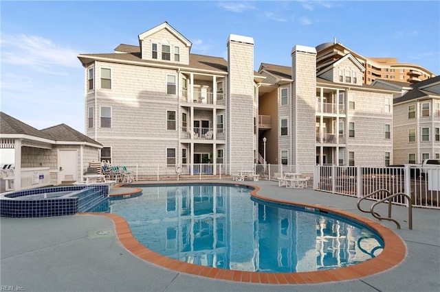 view of pool with a community hot tub