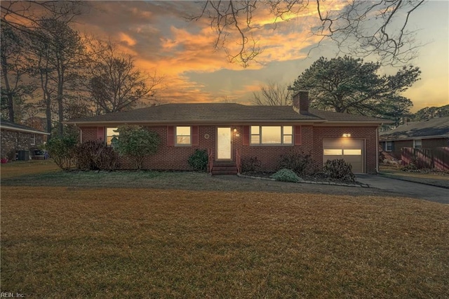 view of front of house with a yard and a garage