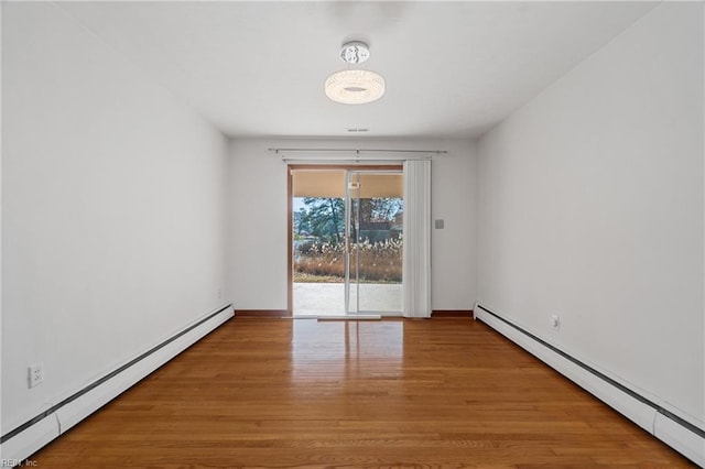 unfurnished room featuring light hardwood / wood-style flooring and baseboard heating