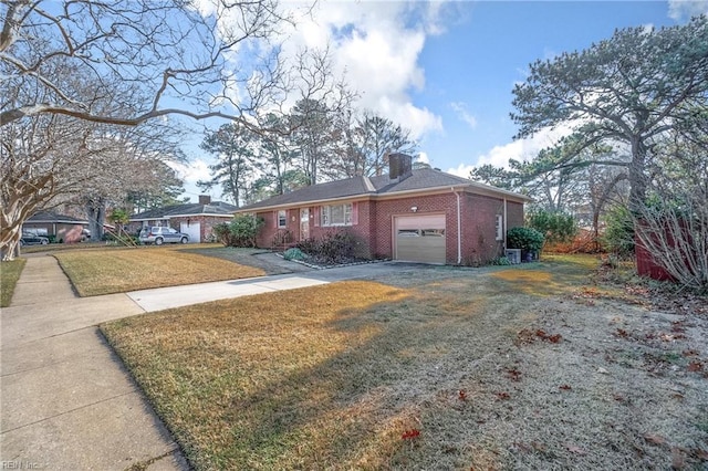 single story home featuring a garage and a front lawn