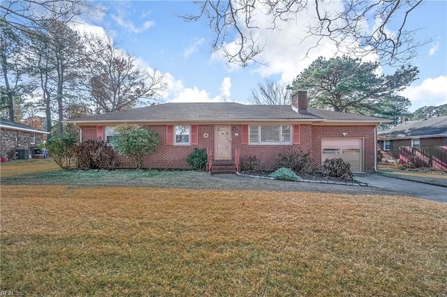 single story home with a garage and a front lawn