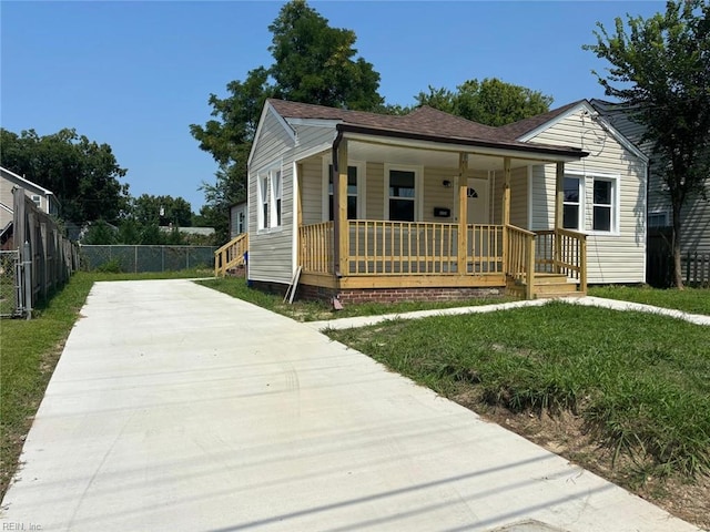 bungalow-style house featuring a front lawn and covered porch