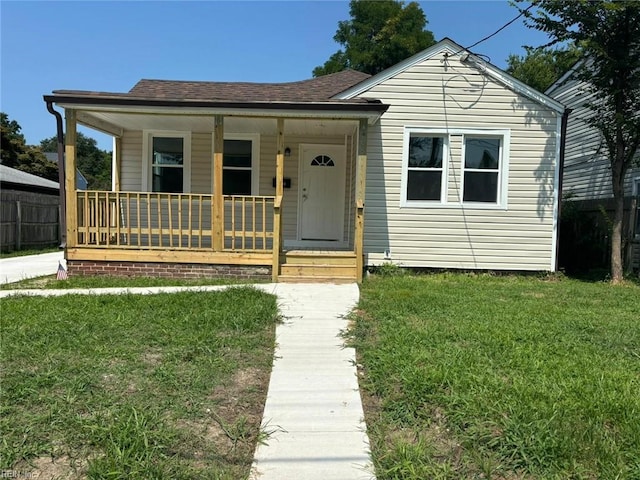 bungalow-style home featuring a porch and a front yard