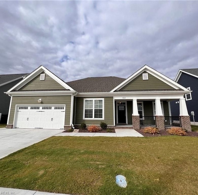 craftsman inspired home with a front yard, a porch, and a garage