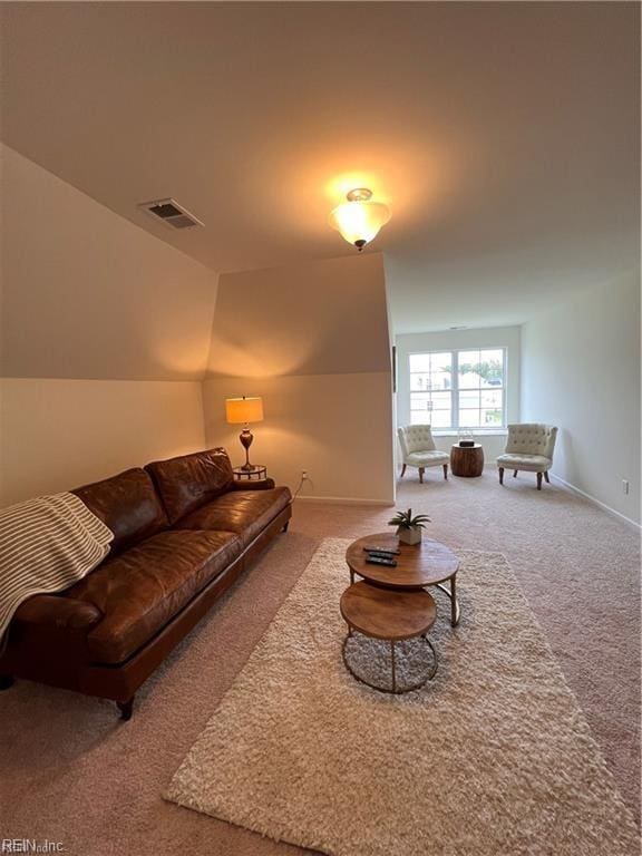 carpeted living room with lofted ceiling