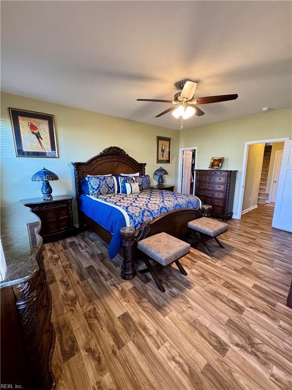 bedroom with hardwood / wood-style floors and ceiling fan