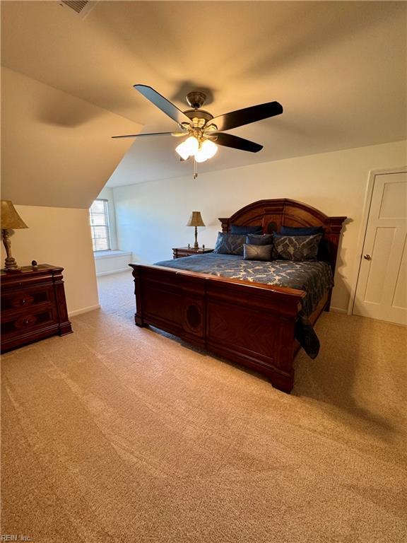 carpeted bedroom featuring ceiling fan and lofted ceiling