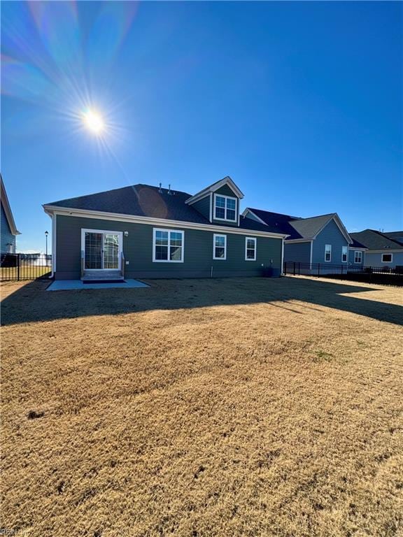 back of house with a yard and a patio