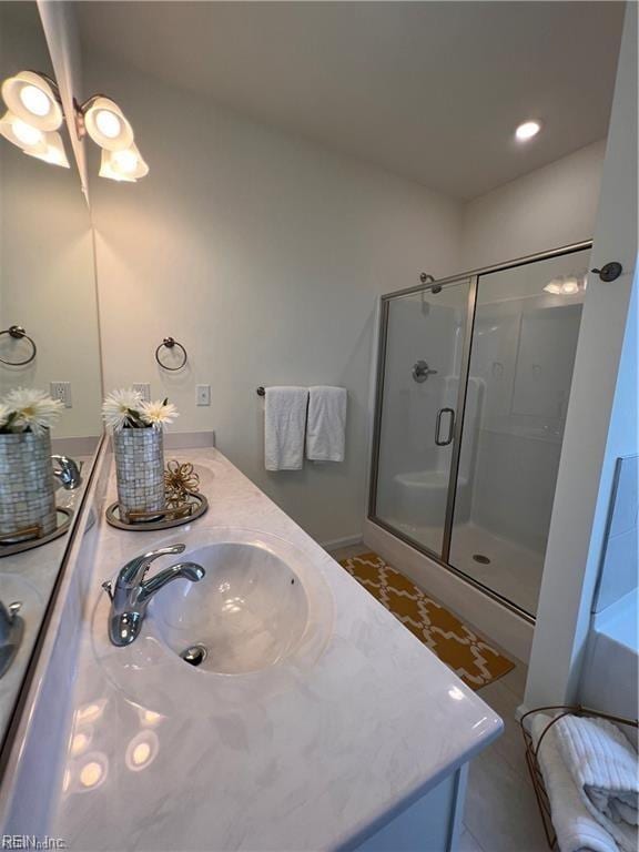 bathroom with vanity and a shower with shower door