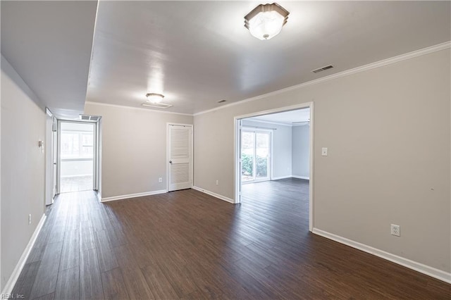 empty room featuring dark hardwood / wood-style floors and ornamental molding