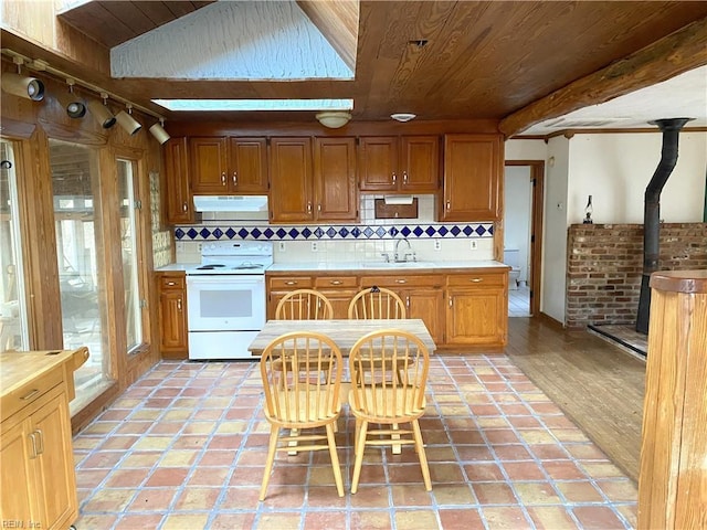 kitchen featuring decorative backsplash, light wood-type flooring, electric range, and sink