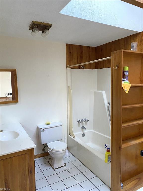 full bathroom featuring tile patterned floors, vanity, toilet, and washtub / shower combination