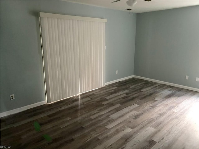 empty room featuring dark hardwood / wood-style flooring and ceiling fan