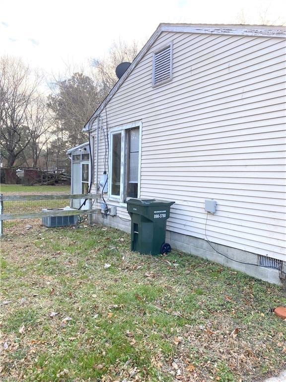 view of side of property with a yard