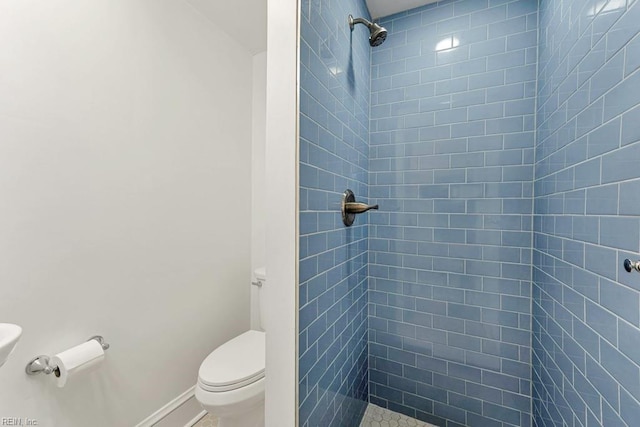 bathroom featuring toilet and tiled shower