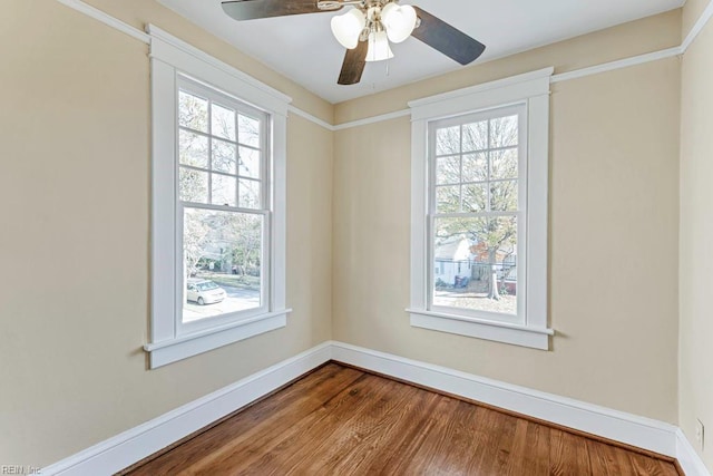 unfurnished room with hardwood / wood-style floors, a wealth of natural light, and ceiling fan