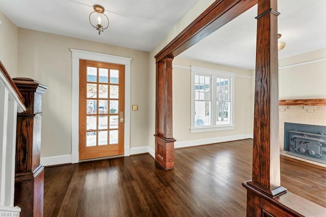 doorway to outside featuring dark hardwood / wood-style flooring and ornate columns