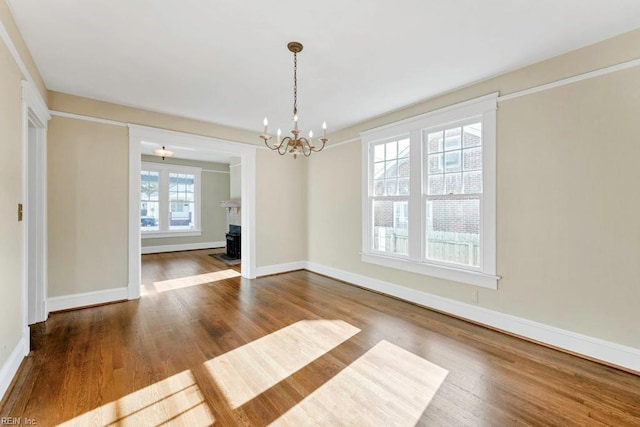 interior space featuring wood-type flooring and a notable chandelier