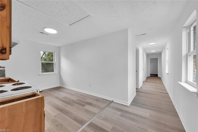 kitchen with light wood-type flooring and a textured ceiling