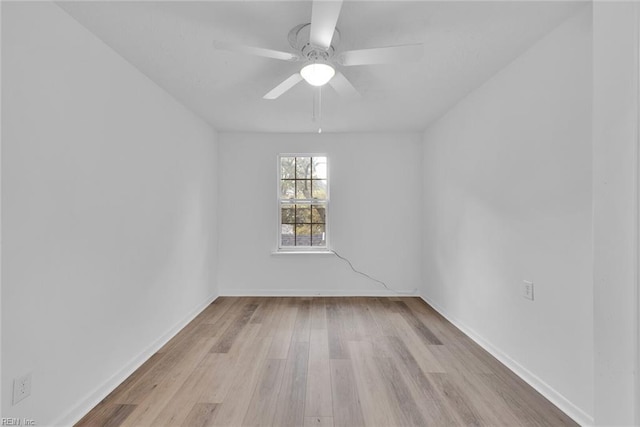 spare room with ceiling fan and light wood-type flooring