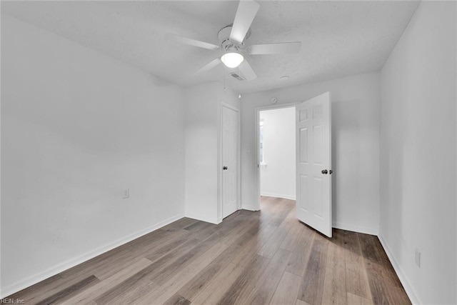 spare room with ceiling fan and light hardwood / wood-style flooring