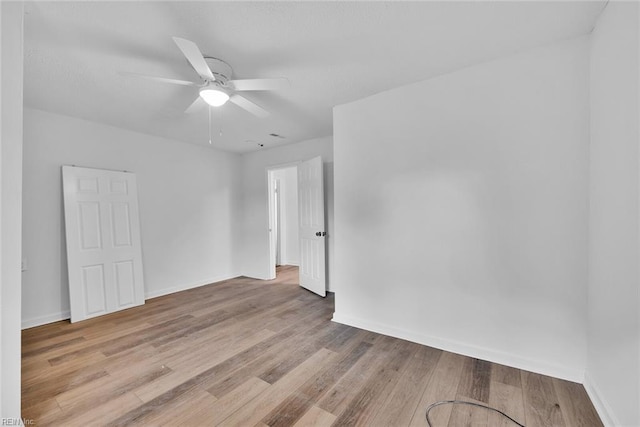 spare room featuring light hardwood / wood-style flooring and ceiling fan