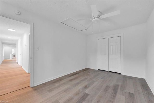 interior space with light wood-type flooring, a closet, and ceiling fan