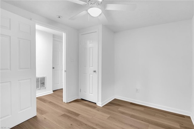 unfurnished bedroom featuring light wood-type flooring and ceiling fan