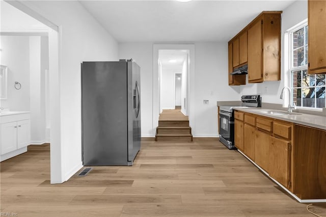 kitchen with light wood-type flooring, stainless steel fridge with ice dispenser, sink, and black electric range