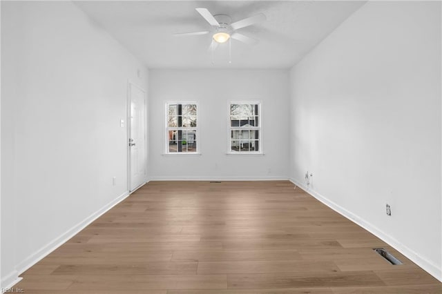 spare room with ceiling fan and light wood-type flooring