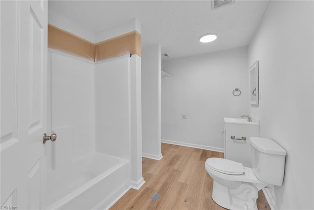 bathroom with vanity, toilet, and wood-type flooring