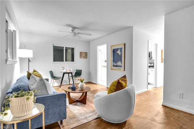 living room with hardwood / wood-style flooring and ceiling fan