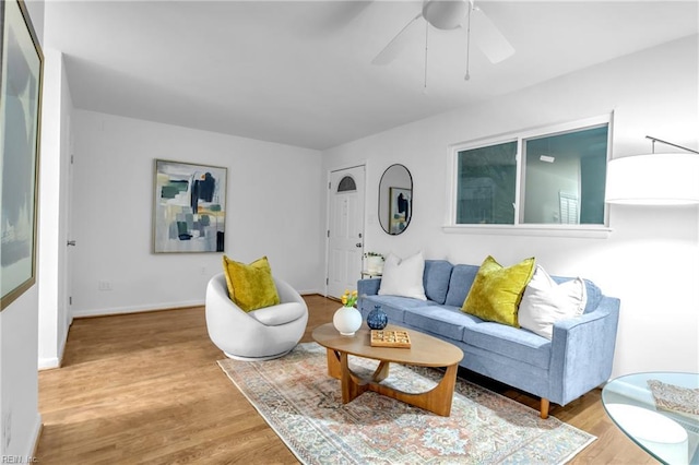 living room featuring ceiling fan and light hardwood / wood-style flooring