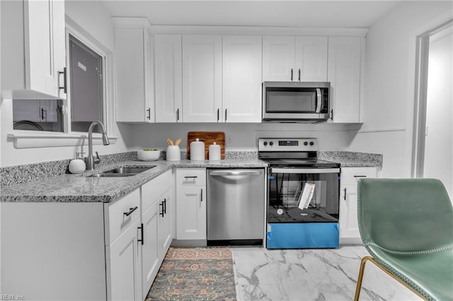 kitchen with sink, white cabinets, and appliances with stainless steel finishes