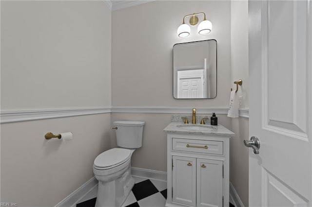 bathroom featuring vanity, ornamental molding, and toilet