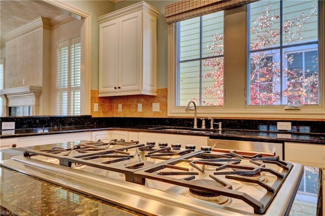 kitchen with white cabinetry and dark stone counters