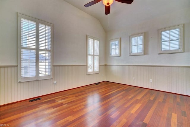 spare room featuring wood-type flooring and a healthy amount of sunlight