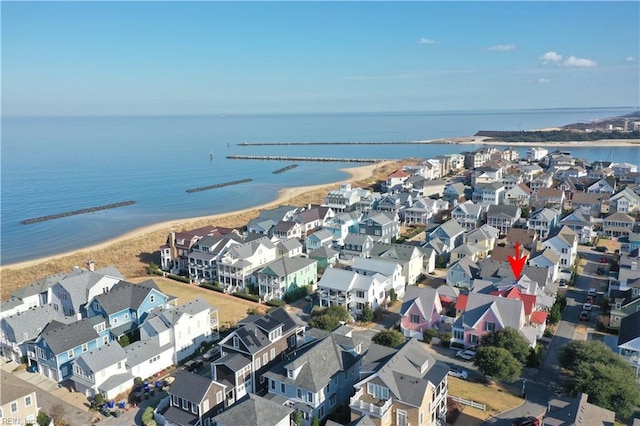 drone / aerial view featuring a water view and a view of the beach