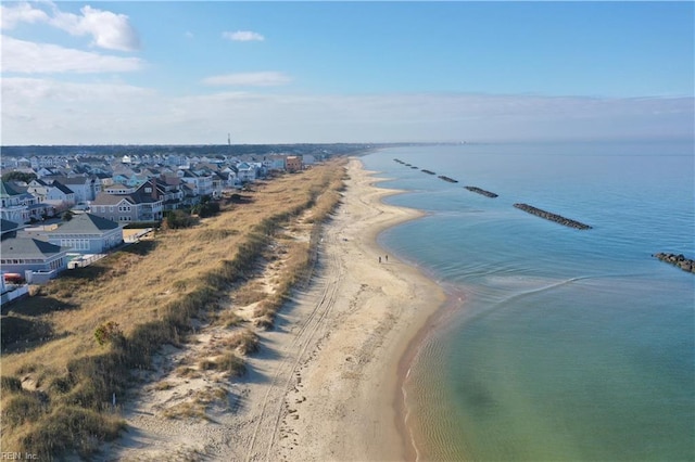 drone / aerial view with a beach view and a water view