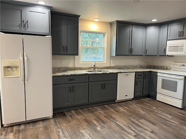 kitchen with gray cabinetry, white appliances, dark wood-type flooring, and sink